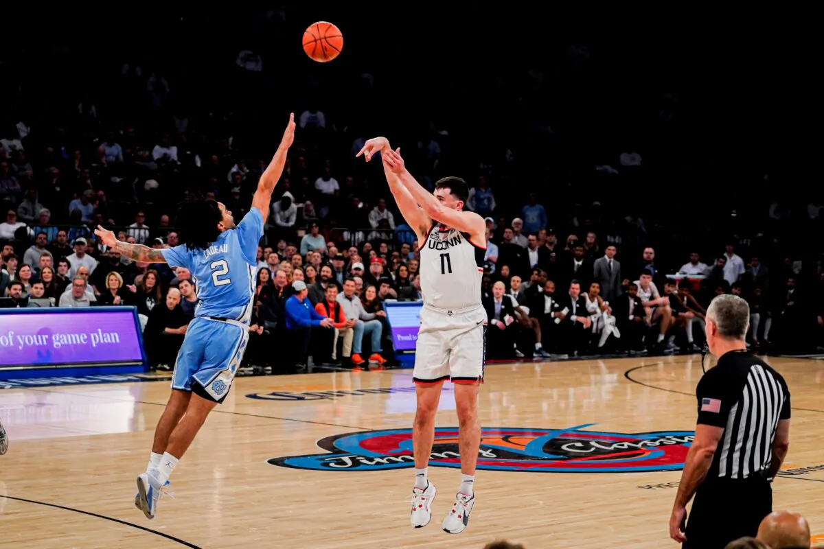 UConn forward Alex Karaban (11) shoots the ball over North Carolina guard Elliot Cadeau (2) during the first half of an NCAA college basketball game in New York on Dec. 5, 2023. (Peter K. Afriyie/AP Photo)