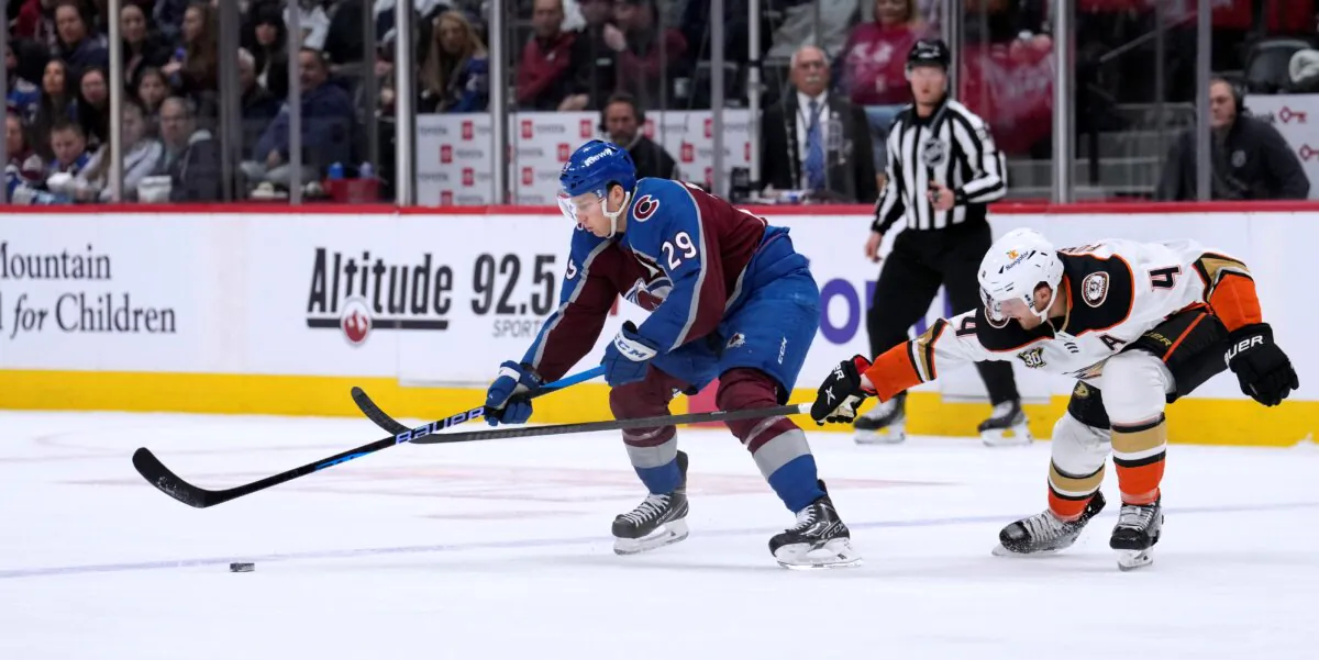 Colorado Avalanche center Nathan MacKinnon (L), controls the puck as Anaheim Ducks defenseman Cam Fowler pursues during the first period of an NHL hockey game in Denver on Dec. 5, 2023. (David Zalubowski/AP Photo)