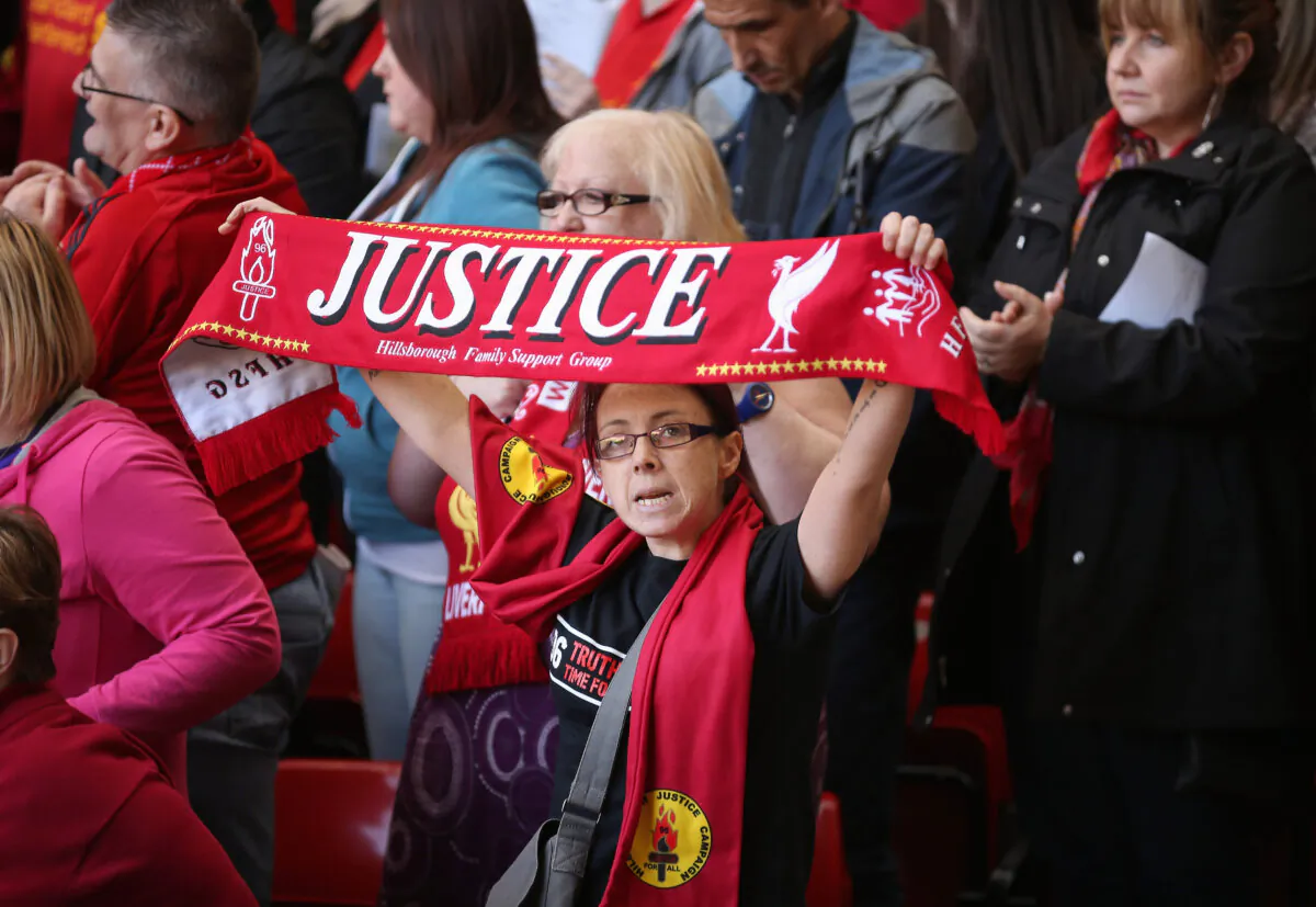 Liverpool fans sing "You'll Never Walk Alone" during the Hillsborough memorial service marking the 25th anniversary of the Hillsborough Disaster at Anfield stadium in Liverpool, England, on April 15, 2014. (Christopher Furlong/Getty Images)