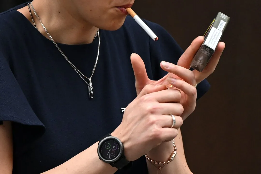 A woman is seen smoking a cigarette in central London on June 9, 2022. (Justin Tallis/AFP via Getty Images)