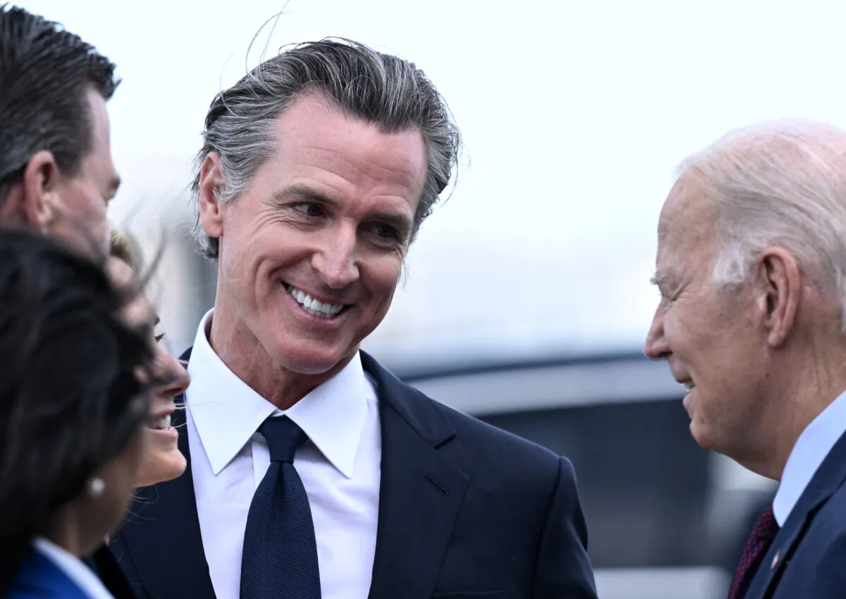 President Joe Biden (R) greets California Governor Gavin Newsom and others after disembarking Air Force One at San Francisco International Airport in San Francisco on Nov. 14, 2023, as he arrives to attend the Asia-Pacific Economic Cooperation (APEC) leaders' week. (Brendan Smialowski/AFP via Getty Images)