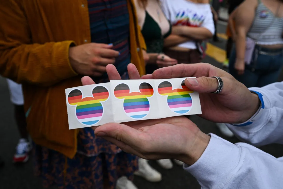Disney Mickey Mouse ears stickers in rainbow colors are offered to spectators by the Disney contingent at the 2023 LA Pride Parade in Hollywood, Calif., on June 11, 2023. (Robyn Beck/AFP via Getty Images)