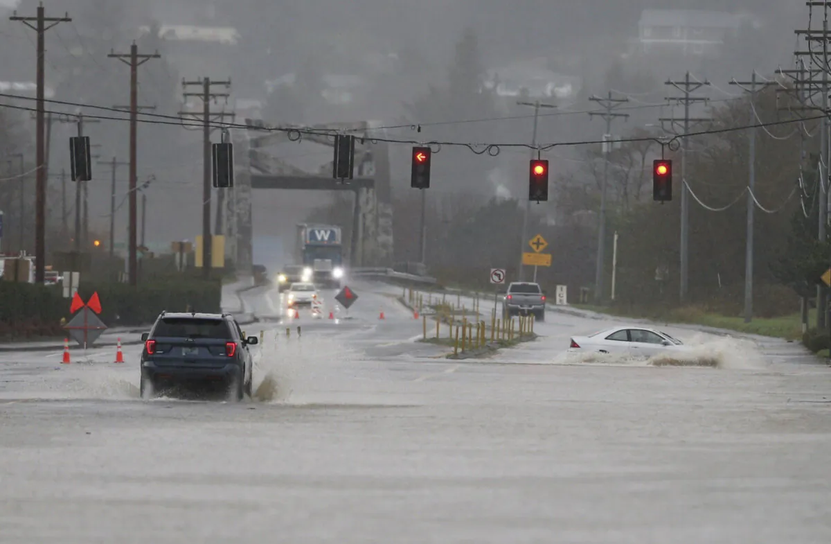 Heavy rain causes high water and flooding along Highway 101 in Tillamook, Ore., on Dec. 5, 2023. (Dave Killen/The Oregonian via AP)