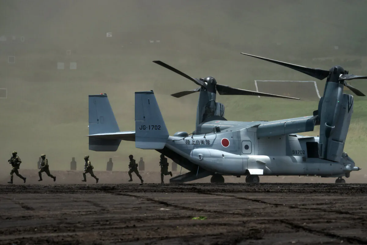 Members of the Japan Ground Self-Defense Force (JGSDF) disembark from a V-22 Osprey aircraft during a live fire exercise at East Fuji Maneuver Area on May 28, 2022 in Gotemba, Shizuoka, Japan, on May 28, 2022. The annual live-fire drill took place as Japanese Prime Minister Fumio Kishida pledged to boost defense spending after a summit with U.S. President Joe Biden and other 'Quad' leaders at the time. (Tomohiro Ohsumi/Getty Images)