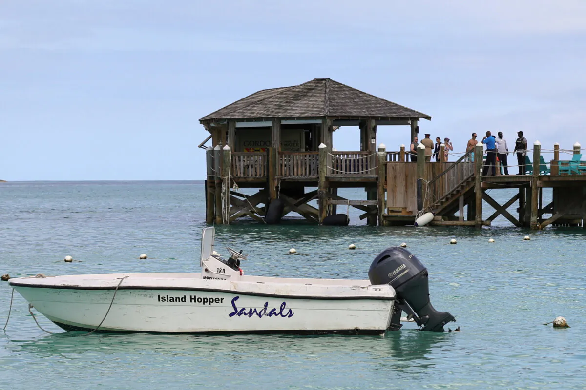 People gather on the resort pier after what police described as a fatal shark attack against a tourist at Sandals Royal Bahamian resort, in Nassau, Bahamas, on Dec. 4, 2023. (Dante Carrer/Reuters)
