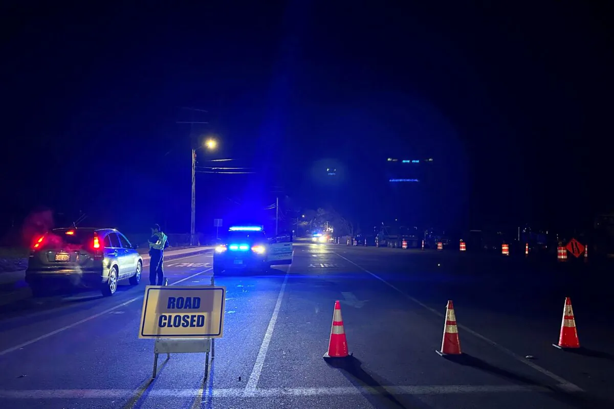 Police block a roadway in Waltham, Mass., after a person in a vehicle struck and injured utility workers before stealing a police cruiser, on Dec. 6, 2023. (Michael Casey/AP Photo)