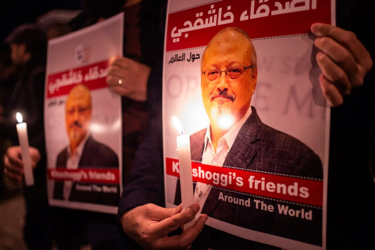 People hold posters picturing slain Saudi journalist Jamal Khashoggi during a gathering outside the Saudi Arabia Consulate in Istanbul on Oct. 25, 2018. (Yasin Akgul/AFP via Getty Images)