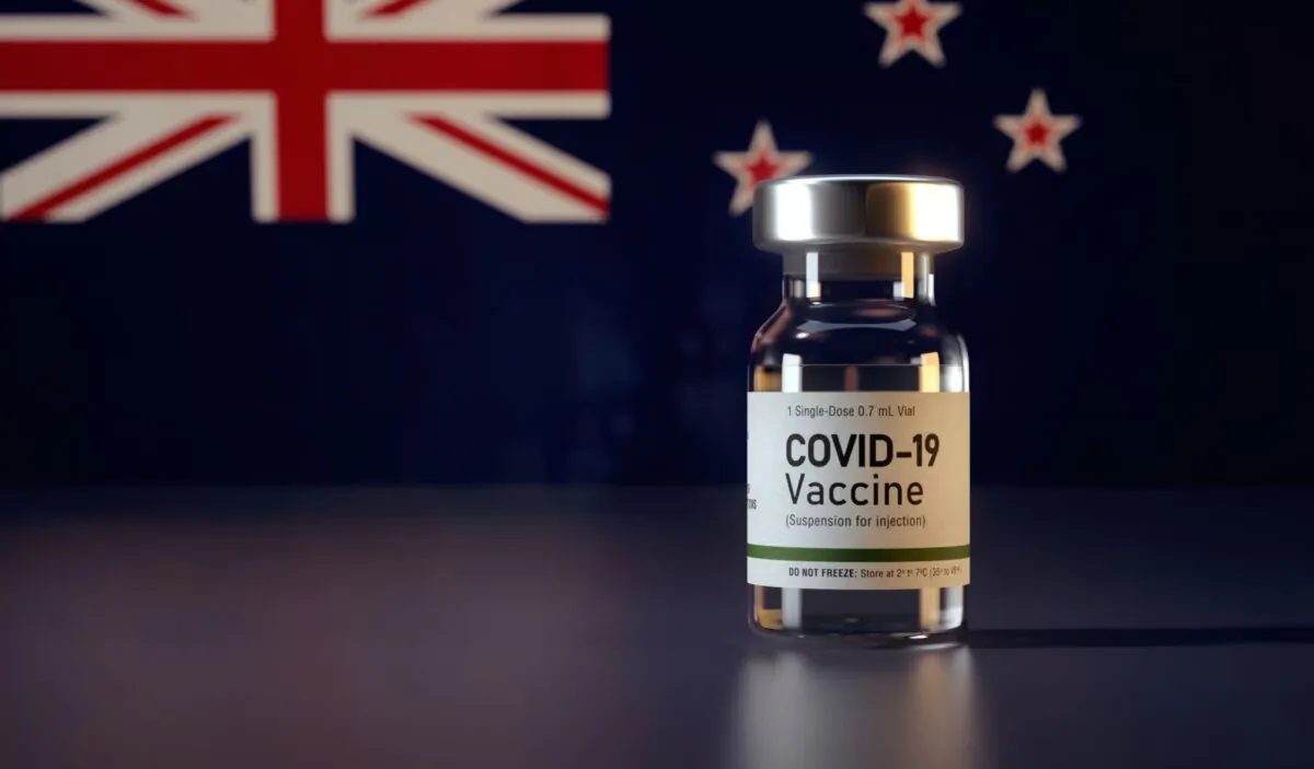 Illustration of a COVID-19 vaccine shot in front of a New Zealand flag. (Mirza Kadic)