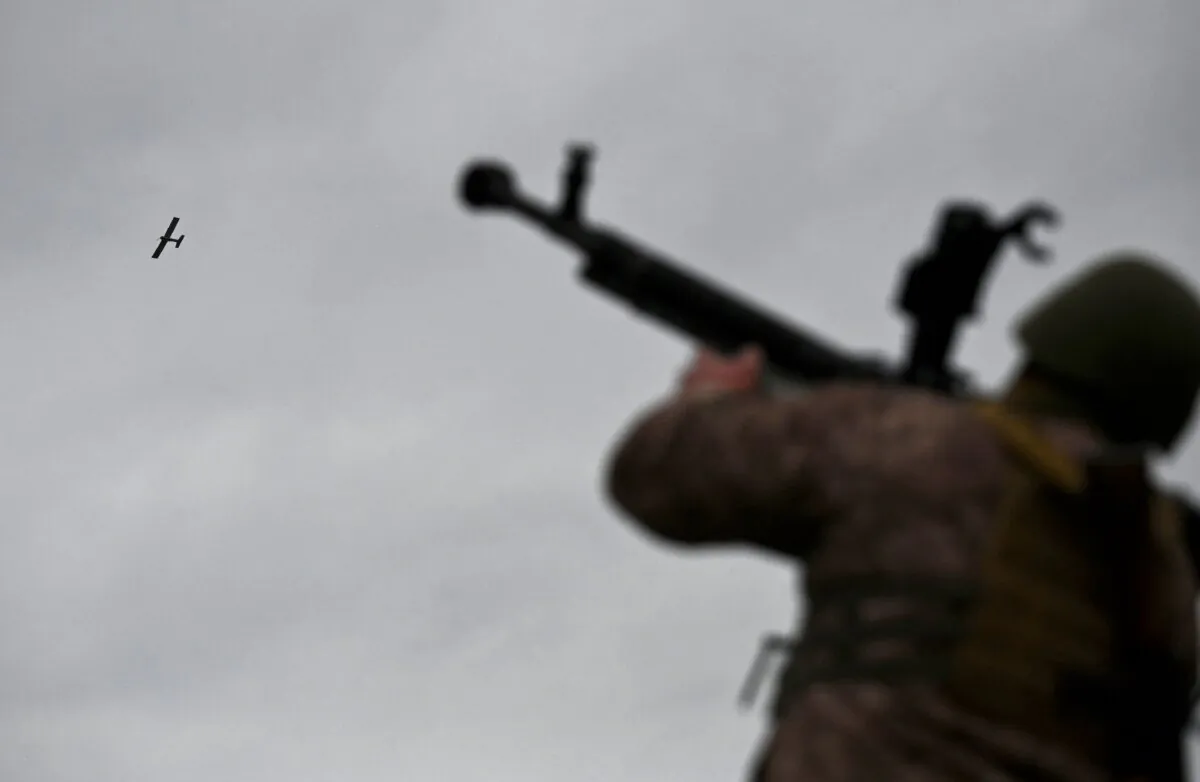 A Ukrainian serviceman aims a machine gun as a drone flies during an anti-drone drill in Chernigiv region on Nov. 11, 2023. (Photo by Sergei Supinsky/AFP via Getty Images)