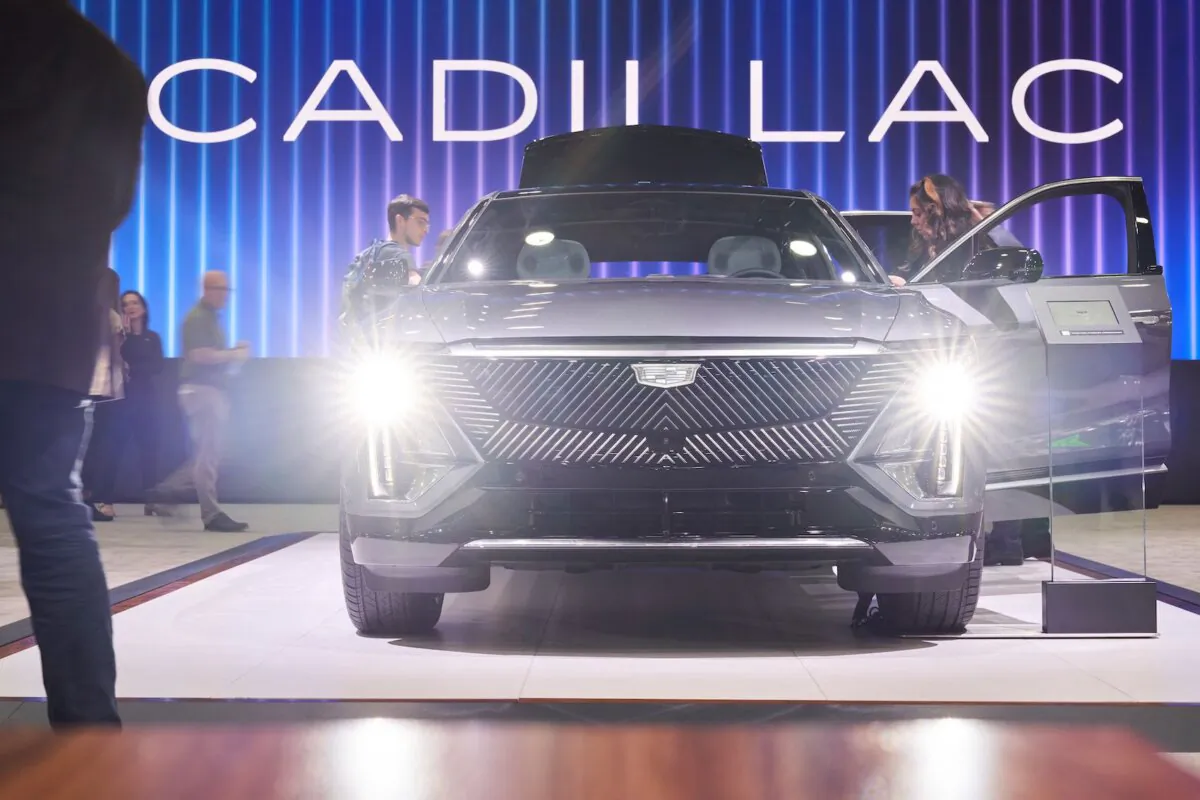 People look at the Cadillac Lyriq electric vehicle at the Cadillac booth at the North American International Auto Show in Detroit, Mich. on Sept. 14, 2022. (Geoff Robins/AFP via Getty Images)