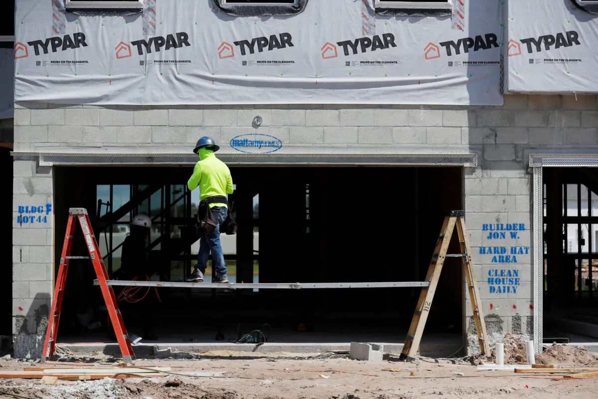 A carpenter works on building new townhomes that are still under construction while building material supplies are in high demand in Tampa, Fla., on May 5, 2021. (Octavio Jones/Reuters)
