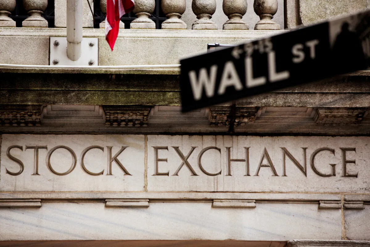 A street sign for Wall Street hangs in front of the New York Stock Exchange on May 8, 2013. (Lucas Jackson/Reuters)