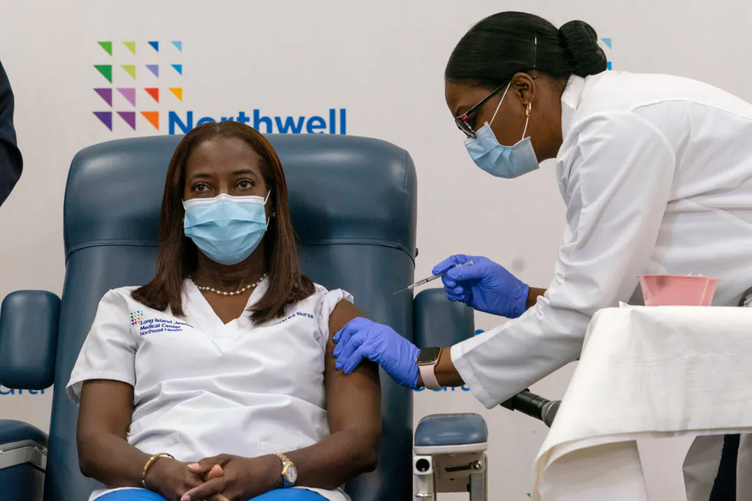 A nurse at the Long Island Jewish Medical Center is injected with the COVID-19 vaccine in Queens, N.Y., on Dec. 14, 2020. (Mark Lennihan/Getty Images)