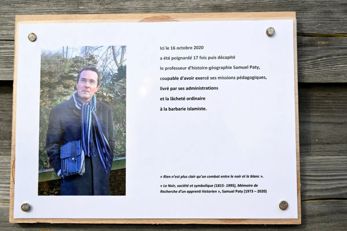 A commemorative plaque for slain teacher Samuel Paty near the Bois d'Aulne school in Conflans-Sainte-Honorine, outside Paris on Oct. 16, 2023. (Bertrand Guay/Pool via Reuters)