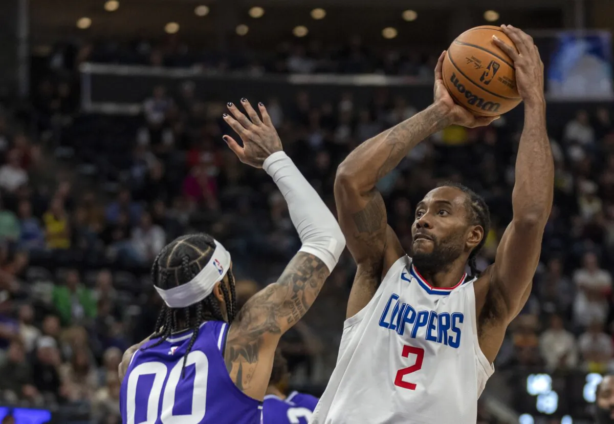 Los Angeles Clippers forward Kawhi Leonard (2) shoots over Utah Jazz guard Jordan Clarkson (00), during the second half of an NBA basketball game in Salt Lake City on Dec. 8, 2023. (Rick Egan/AP Photo)