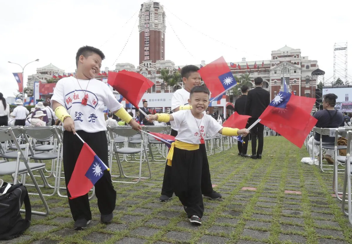 Children wave Taiwan's national flags during National Day celebrations in front of the Presidential Building in Taipei, Taiwan, Oct. 10, 2023. (The Canadian Press/AP-Chiang Ying-ying)