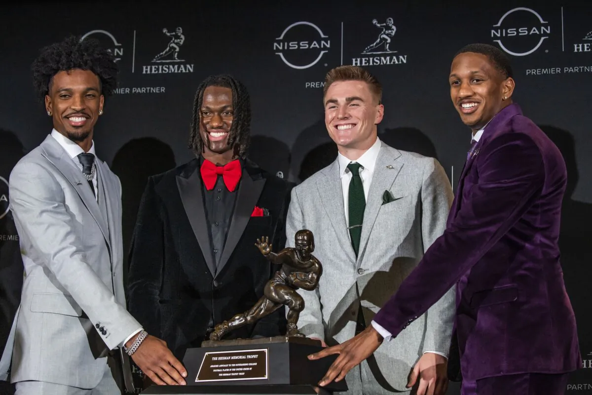 Heisman Trophy finalists (L to R) LSU quarterback Jayden Daniels, Ohio State wide receiver Marvin Harrison Jr., Oregon quarterback Bo Nix and Washington quarterback Michael Penix Jr. pose with the trophy after attending a news conference before the award ceremony in New York on Dec. 9, 2023. (Eduardo Munoz Alvarez/AP Photo)