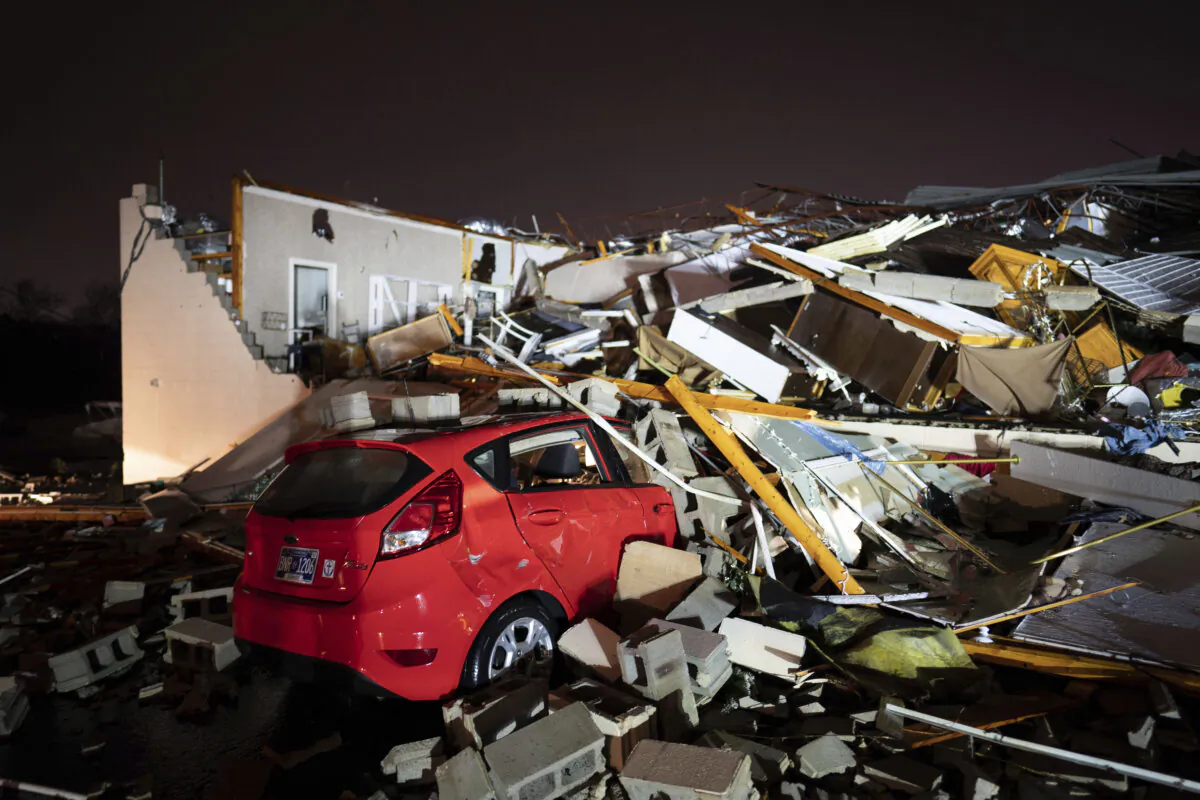 A car is buried under rubble on Main Street after a tornado hit Hendersonville, Tenn., on Dec. 9, 2023. (Andrew Nelles/The Tennessean via AP)