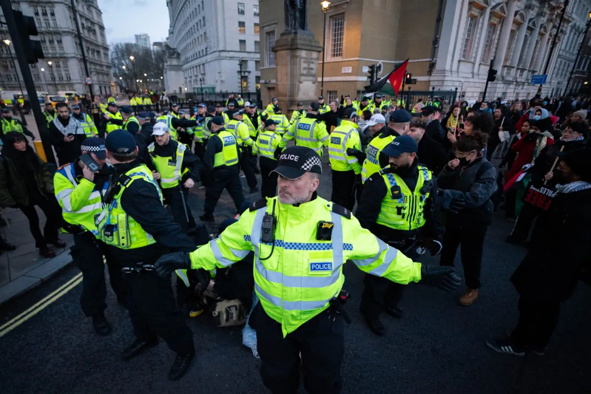Police detain a person during a pro-Palestine march on Whitehall, organised by the Palestine Solidarity Campaign, in central London, on Dec. 9, 2023. (James Manning/PA Wire)
