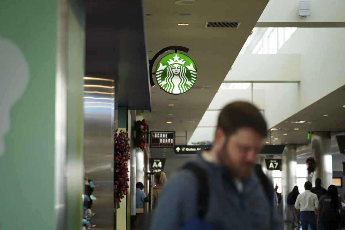 A person passes by a Starbucks coffee sign at Birmingham–Shuttlesworth International Airport in Birmingham, Ala., on Dec. 7, 2023. (Madalina Vasiliu/The Epoch Times)