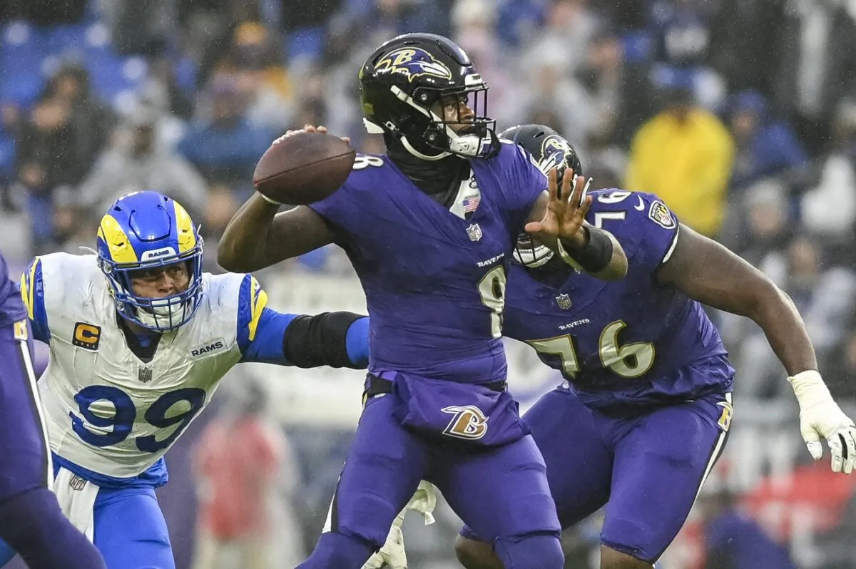 Los Angeles Rams defensive tackle Aaron Donald (99) attempts a sack of Baltimore Ravens quarterback Lamar Jackson (8) during the first half in Baltimore, Maryland on Dec. 10, 2023. (Tommy Gilligan/USA TODAY Sports)