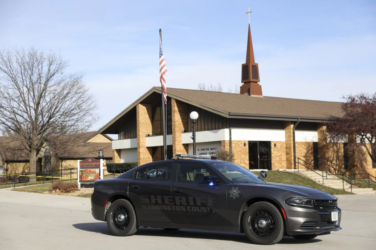The Washington County Sheriff's office investigates the scene of a fatal stabbing on a Catholic priest in the rectory of St. John the Baptist Church in Fort Calhoun, Neb., on Dec. 10, 2023. (Nikos Frazier/Omaha World-Herald via AP)