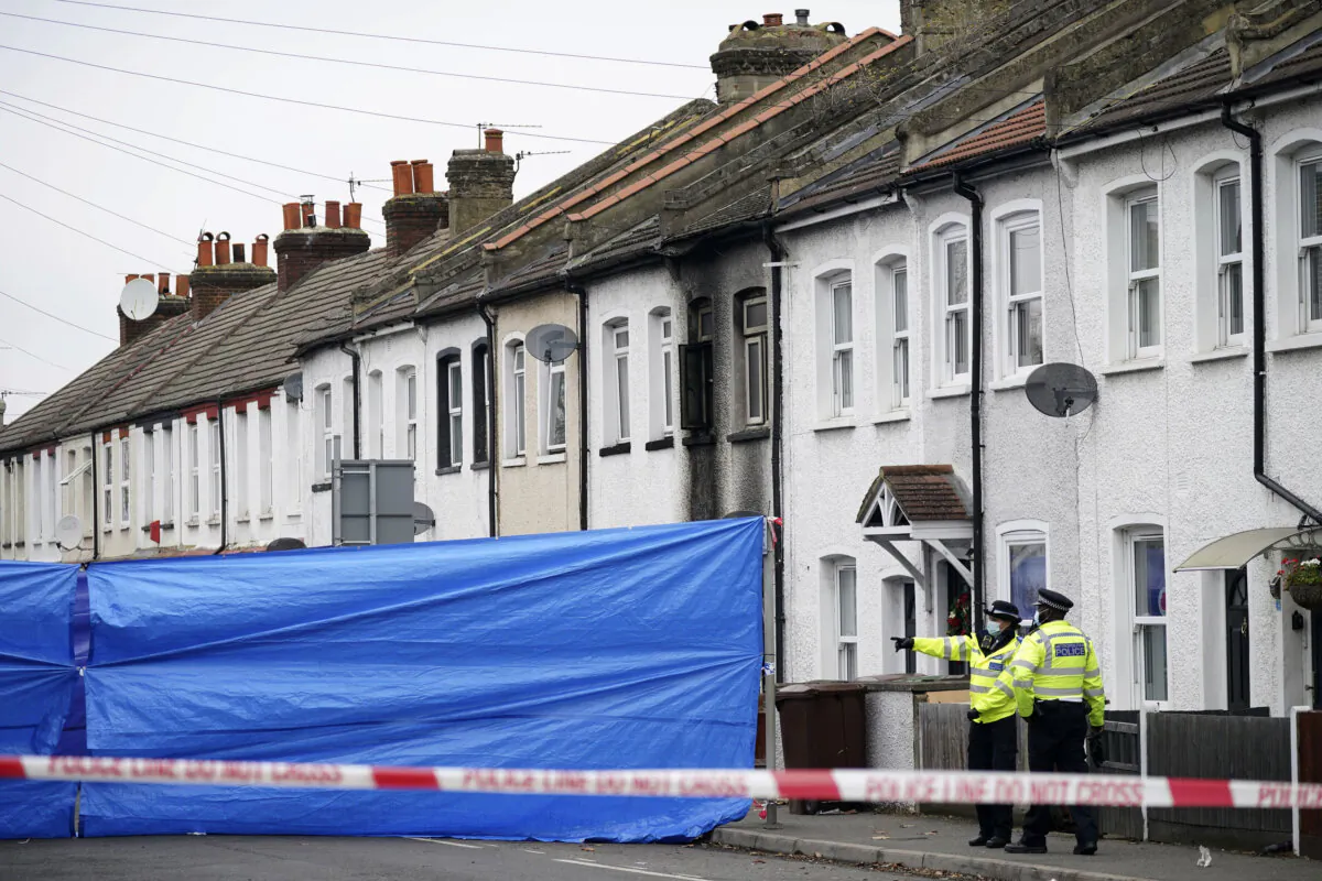 Police cordon off a property in Collingwood Road, Sutton, south London, where brothers Kyson and Bryson Hoath, aged four, and Leyton and Logan Hoath, aged three, died in a fire on Dec. 16, 2021. (Yui Mok/PA via AP)