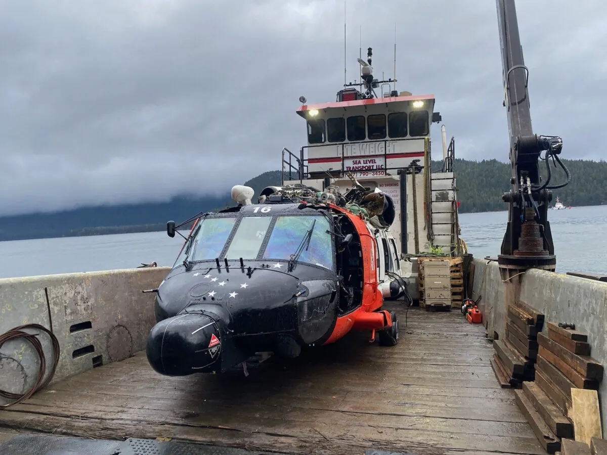 A U.S. Coast Guard MH-60 Jayhawk helicopter from Air Station Sitka on a boat after being recovered from the site of a crash near Read Island, Alaska, on Dec. 8, 2023. (Air Station Sitka/U.S. Coast Guard via AP)
