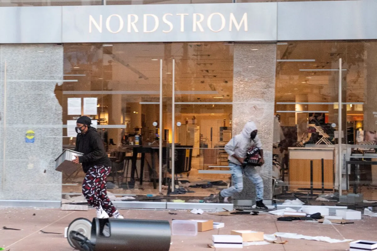 People are seen looting stores at the Grove shopping center in the Fairfax District of Los Angeles on May 30, 2020. (Valerie Macon/AFP via Getty Images)