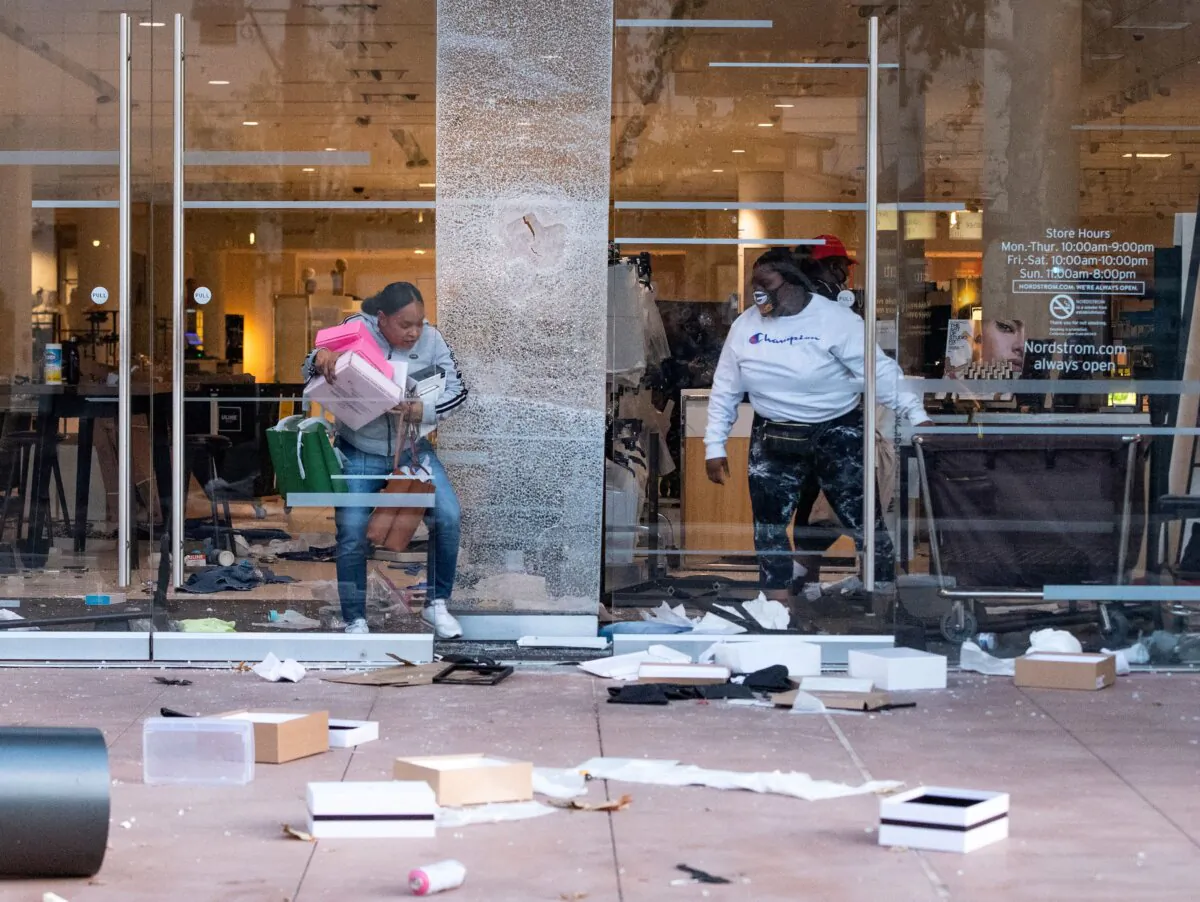 People are seen looting stores at the Grove shopping center following a protest, in the Fairfax District of Los Angeles on May 30, 2020. (Valerie Macon/AFP via Getty Images)