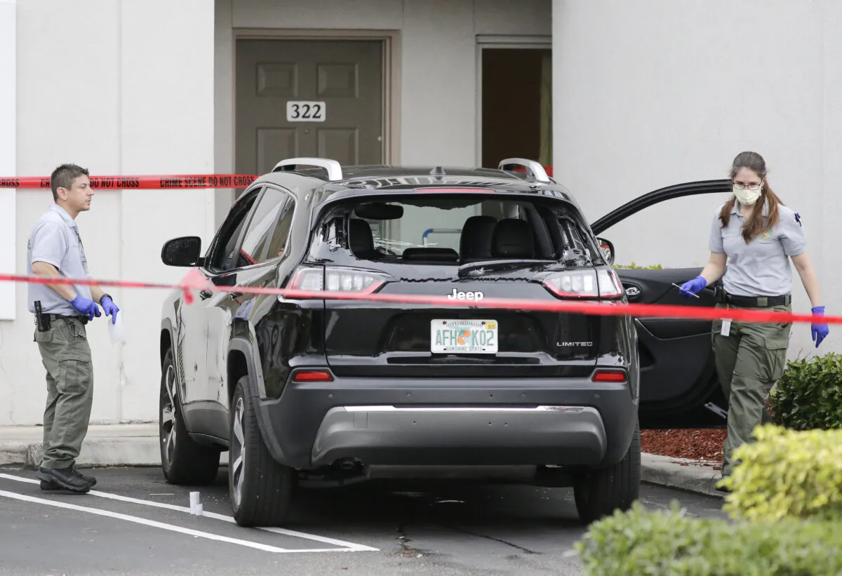 Forensic technicians work on the vehicle authorities say officers fired shots at, that breached security at President Donald Trump's Mar-a-Lago resort in Palm Beach, Fla., on Jan. 31, 2020. (Terry Renna/AP Photo)