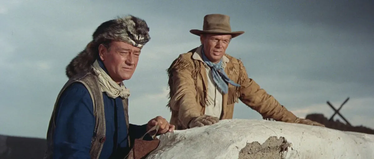 Drawing a line against tyranny—Cols. Davy Crockett (John Wayne, L) and Jim Bowie (Richard Widmark), in “The Alamo.” (United Artists)
