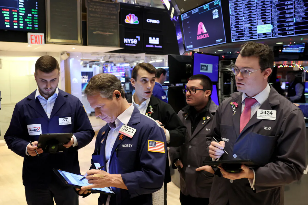 Traders gather at the post that trades Alaska Airlines stock on the floor at the New York Stock Exchange (NYSE) in New York City on Dec. 4, 2023. (Brendan McDermid/Reuters)