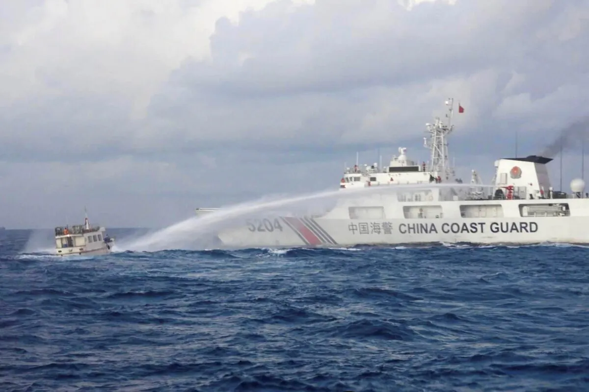 A Chinese Coast Guard ship uses water cannons on Philippine navy-operated supply boat M/L Kalayaan as it approaches Second Thomas Shoal, locally known as Ayungin Shoal, in the disputed South China Sea on Dec. 10, 2023. (Philippine Coast Guard via AP)