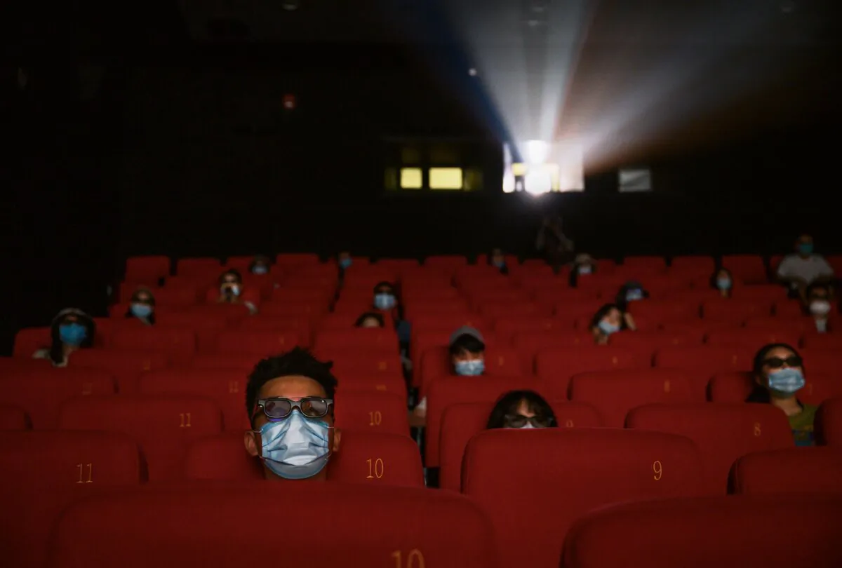 Masked people watch a movie in 3D at a theater in Beijing on July 24, 2020. (Kevin Frayer/Getty Images)