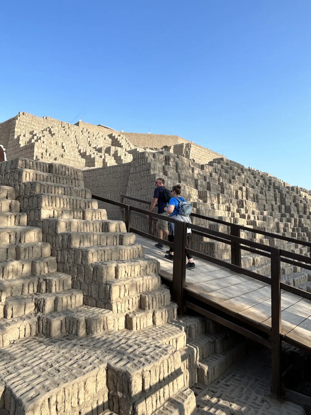 Tourists hike up into ruins of an ancient structure in Lima, Peru. Walking through neighborhoods and cityscapes is one way to better understand a nation's culture. (Colleen Thomas/TNS)