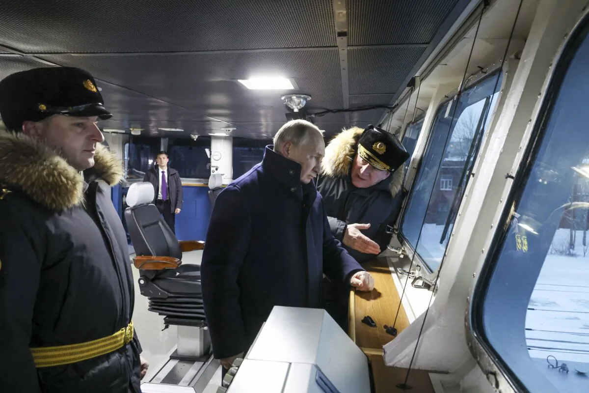 Russian President Vladimir Putin (C) and Admiral Nikolai Yevmenov, Commander-in-Chief of the Russian Navy (R) visit the newest frigate "Admiral of the fleet Kasatonov" during attending a flag-raising ceremony on Monday for newly-built nuclear submarines at the Sevmash shipyard in Severodvinsk in Russia's Archangelsk region on Dec. 11, 2023. (Mikhail Klimentyev, Sputnik, Kremlin Pool Photo via AP)