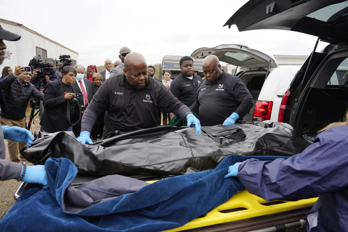 Westhaven Memorial Funeral Home staff adjust the body bag with the remains of Dexter Wade, who died after being hit by a Jackson, Miss., police SUV driven by an off-duty officer, in Raymond, Miss., on Nov. 13, 2023. (Rogelio V. Solis/AP Photo)