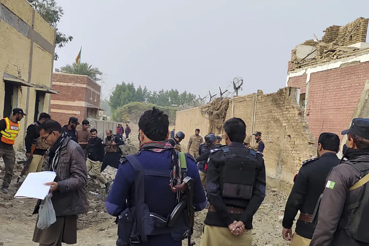 Security officials examine damages on the site of a bombing at a police station on the outskirts of Dera Ismail Khan, Pakistan, on Dec. 12, 2023. (AP Photo)
