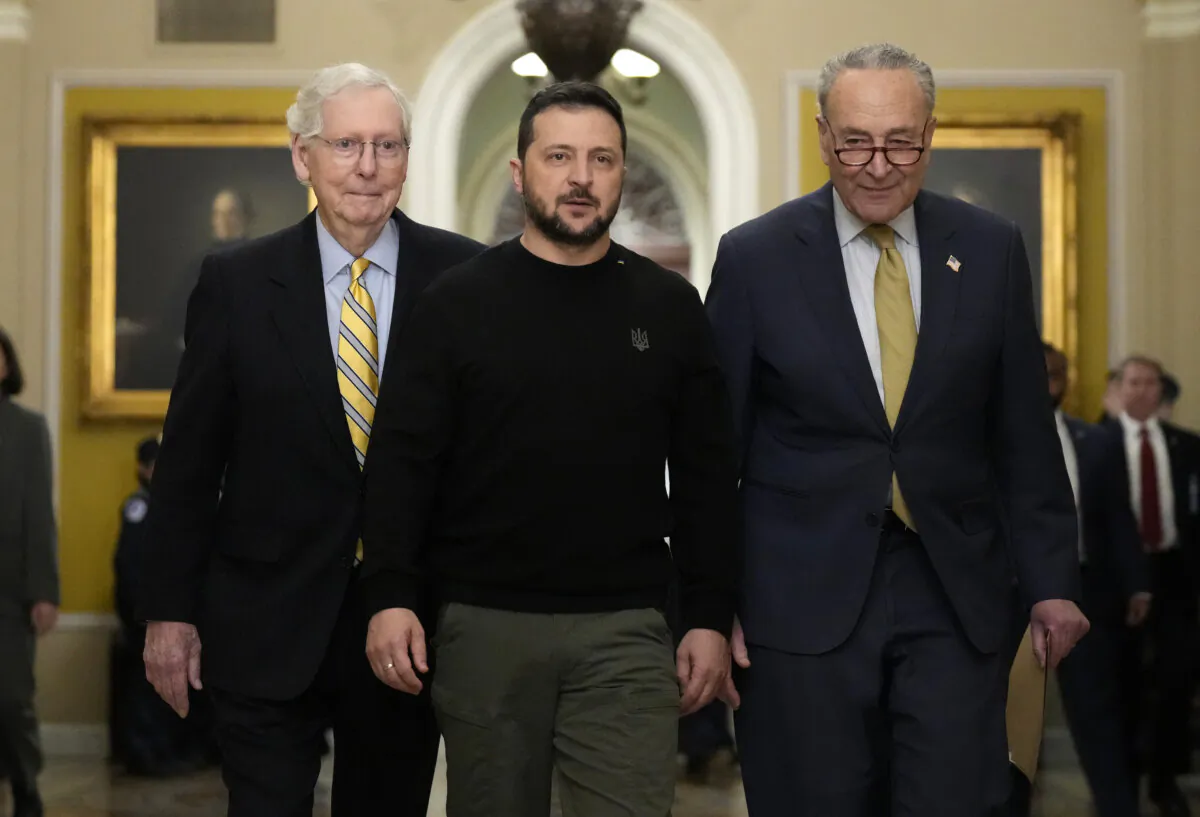 Ukrainian President Volodymyr Zelenskyy (C) walks with Senate Minority Leader Mitch McConnell (R-Ky.) (L) and Senate Majority Leader Chuck Schumer (D-N.Y.) as he arrives at the U.S. Capitol to meet with Congressional leadership in Washington on Dec. 12, 2023. (Drew Angerer/Getty Images)