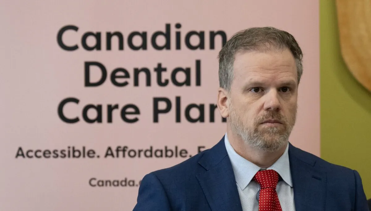 Minister of Health Mark Holland listens to a question following an announcement on dental care, in Ottawa on Dec. 11, 2023. (The Canadian Press/Adrian Wyld)