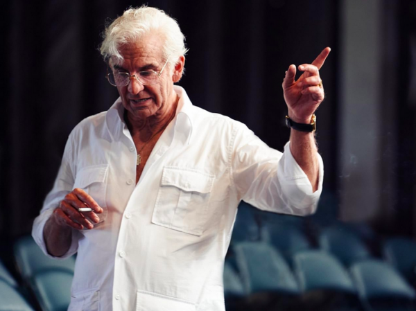 man with white hair and white shirt in MAESTRO