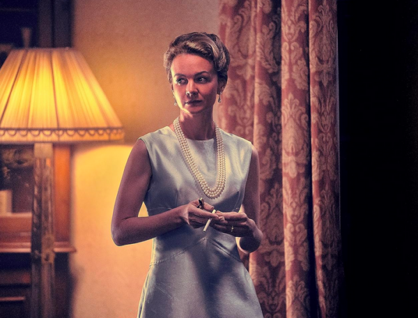 woman in dress and pearls in MAESTRO