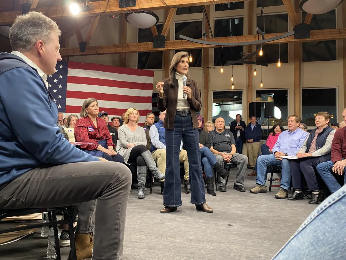 Presidential candidate Nikki Haley spoke to a crowd of supporters at the McIntyre Ski Resort in Manchester, N.H., after winning the endorsement of New Hampshire Gov. Chris Sununu, seen seated in the front. (Alice Giordano/The Epoch Times)