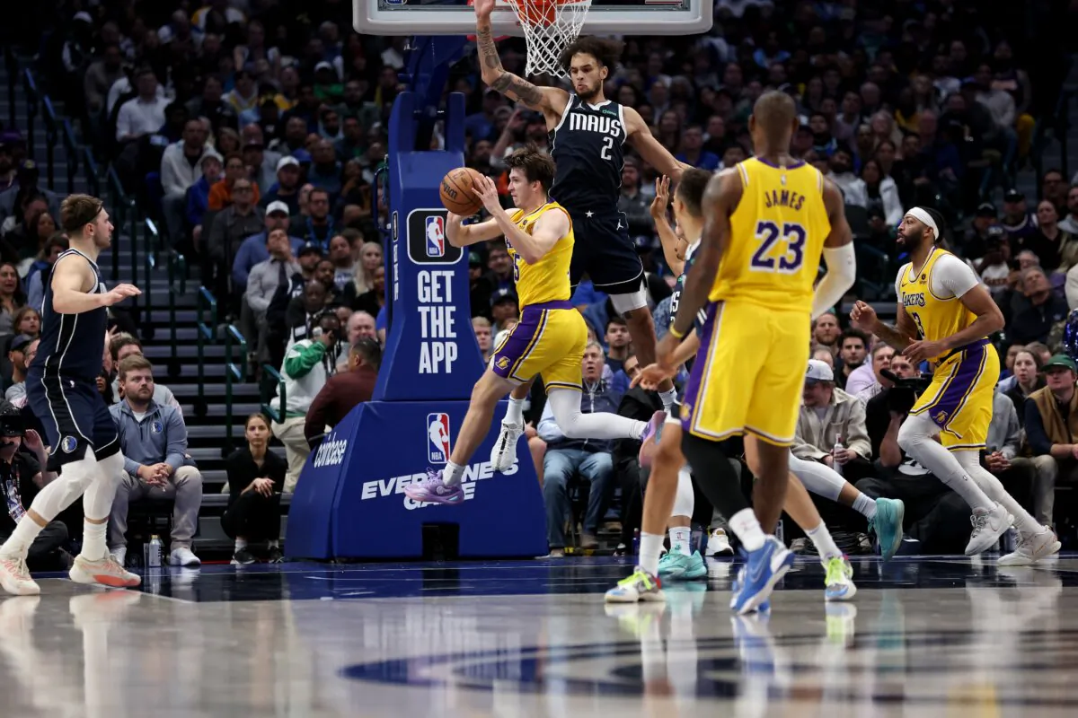 Austin Reaves (15) of the Los Angeles Lakers passes the ball against Dereck Lively II (2) of the Dallas Mavericks in the second half in Dallas on Dec. 12, 2023.(Tim Heitman/Getty Images)