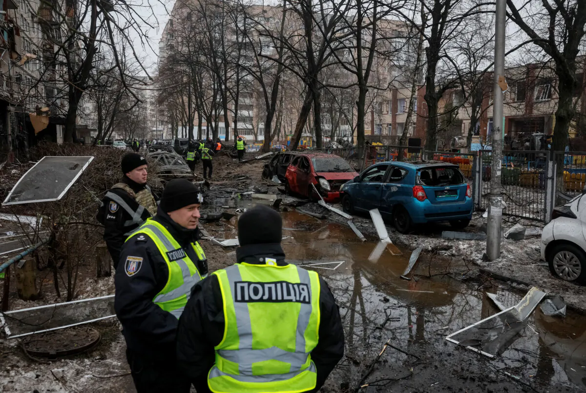 Police guards at a site where an apartment building was damaged during a Russian missile strike, in Kyiv, Ukraine, on Dec. 13, 2023. (Gleb Garanich/Reuters)