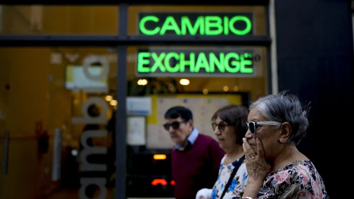 Pedestrians walk past a money exchange shop in Buenos Aires, Argentina, on Oct. 10, 2023. (Natacha Pisarenko/AP Photo)
