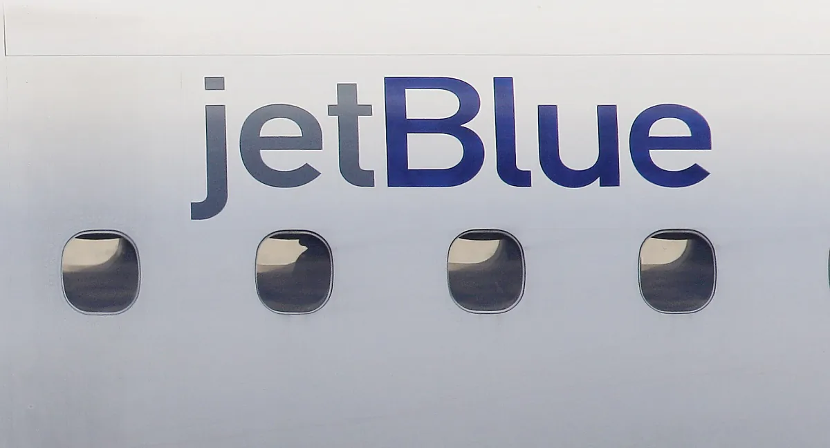 A JetBlue logo on the side of a jet as it taxis at Boston's Logan International Airport on Jan. 20, 2011. (Stephan Savoia/AP Photo)