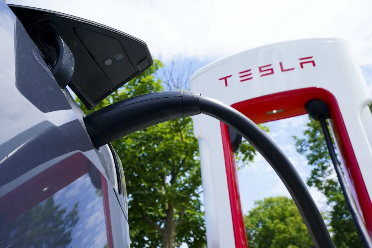 An electric vehicle is charged at a Tesla charging station in Ottawa on July 13, 2022. (The Canadian Press/Sean Kilpatrick)