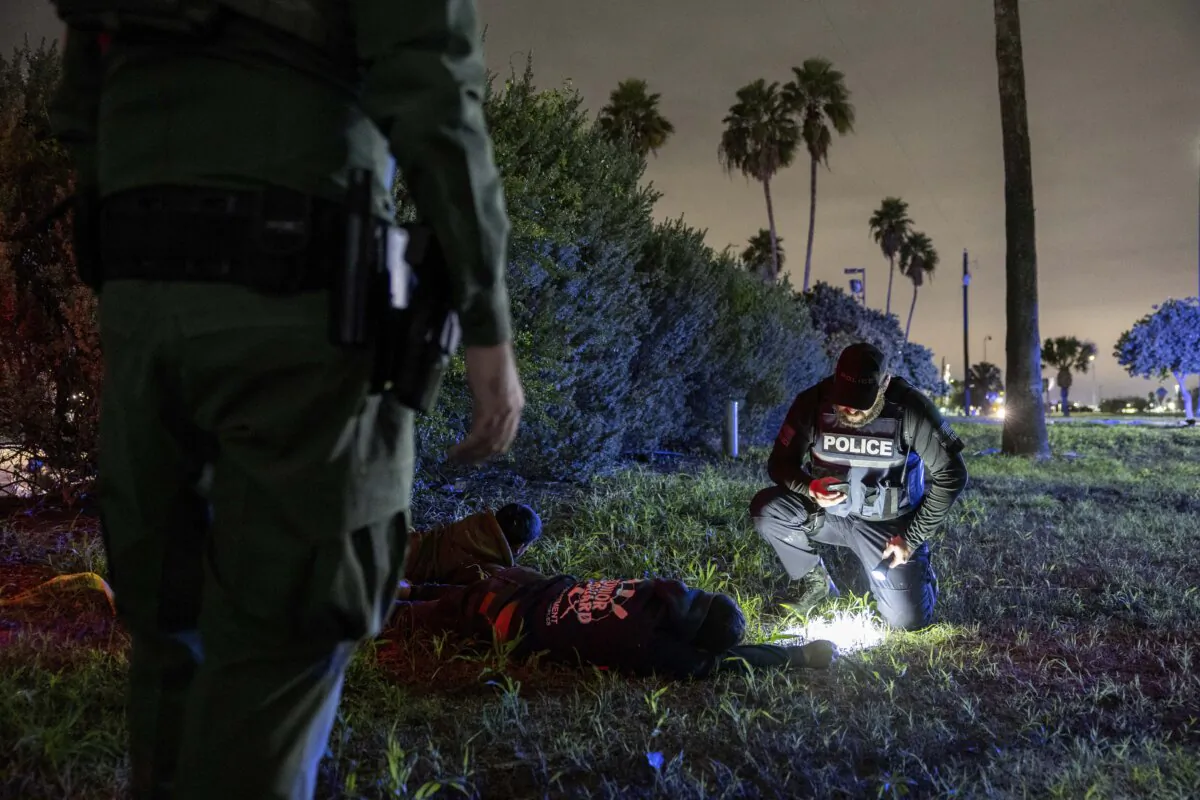 Border Patrol agents and Texas law enforcement officers detain illegal immigrants near the U.S.–Mexico border in McAllen, Texas on Dec. 1, 2022. (John Moore/Getty Images)